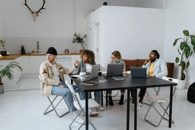 A diverse group of professionals collaborating in a modern and stylish office setting. Coworking capacity and occupancy