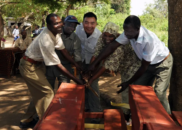 TANA DELTA DISTRICT, Kenya (Nov. 17, 2010) U.S. Navy Lt. Perry Choi, center, team leader for Maritime Civil Affairs Team (MCAT) 205, and educational and community leaders of Ziwani Primary School, cut a ribbon during a dedication ceremony for 200 new desks, a project that was a combined effort betwe. Estimating desks from actual attendance patterns
